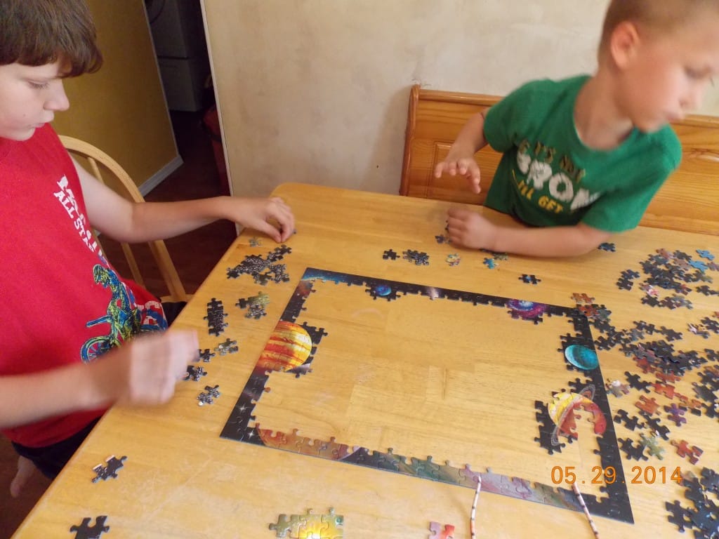 school age kids playing puzzles
