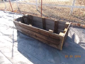 raised garden bed built out of old privacy fencing