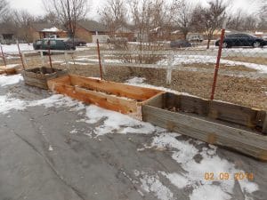 raised beds being lined up in preschool garden