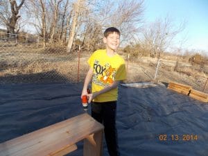 Kids building raised garden beds