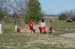 families moving gravel for drainage