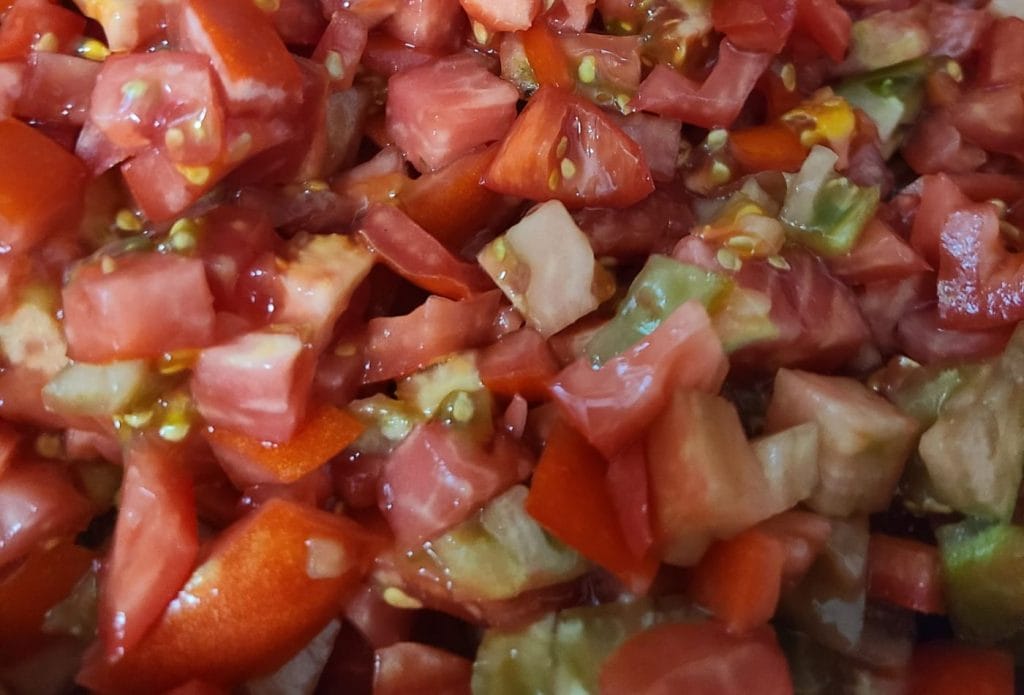 a big giant bowl of diced up tomatoes