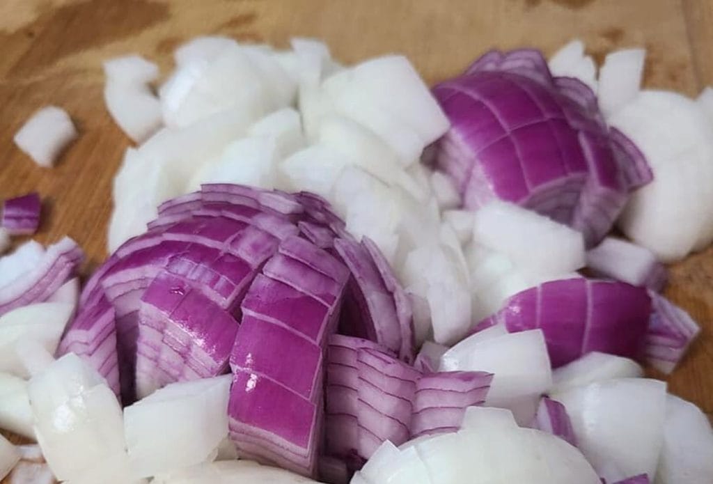 diced onions on a cutting board ready to go in homemade rotel tomatoes