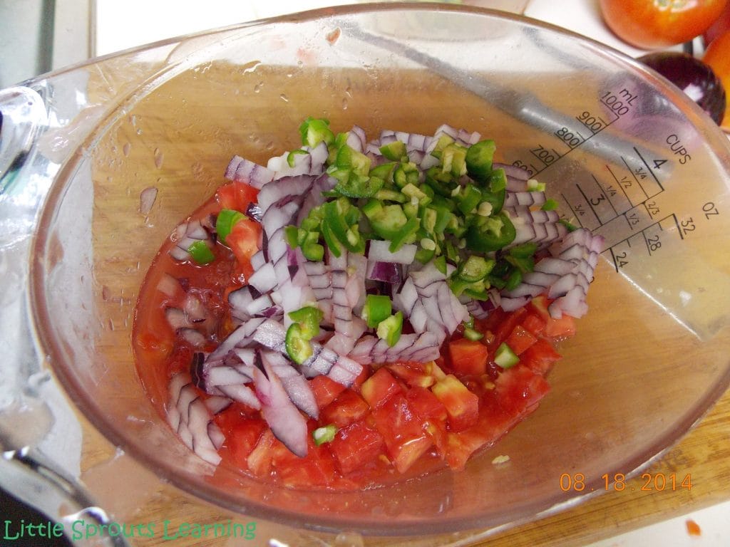 Finely diced tomatoes, onions, and hot peppers in a bowl.