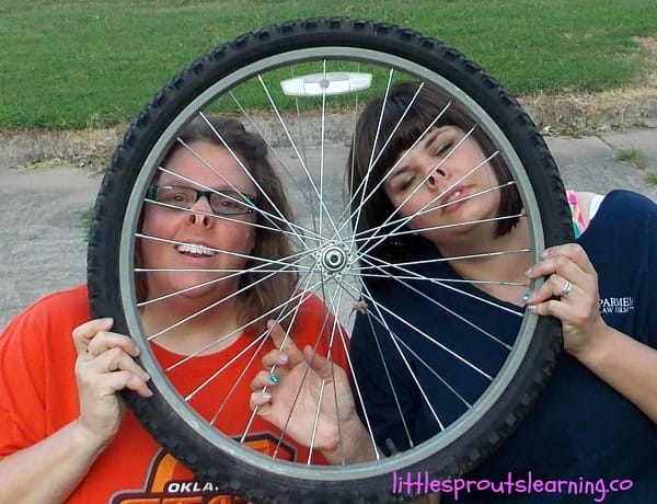 friends being silly making pig noses through a bike tire.
