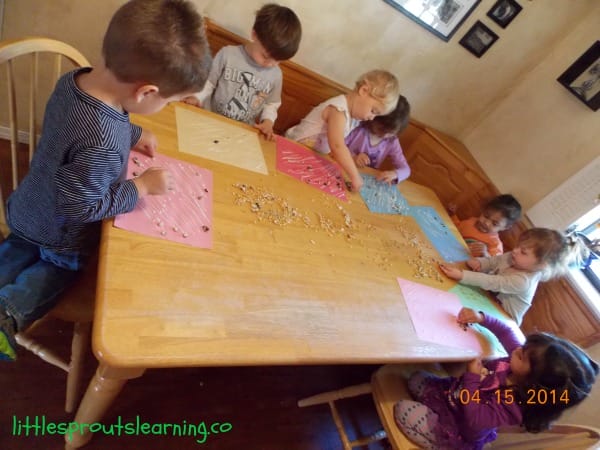 Kids making collages at kitchen table