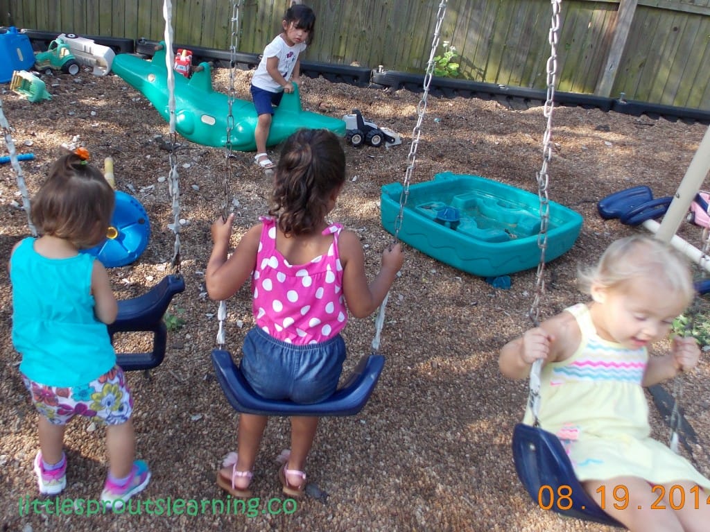 kida playing on swings at daycare