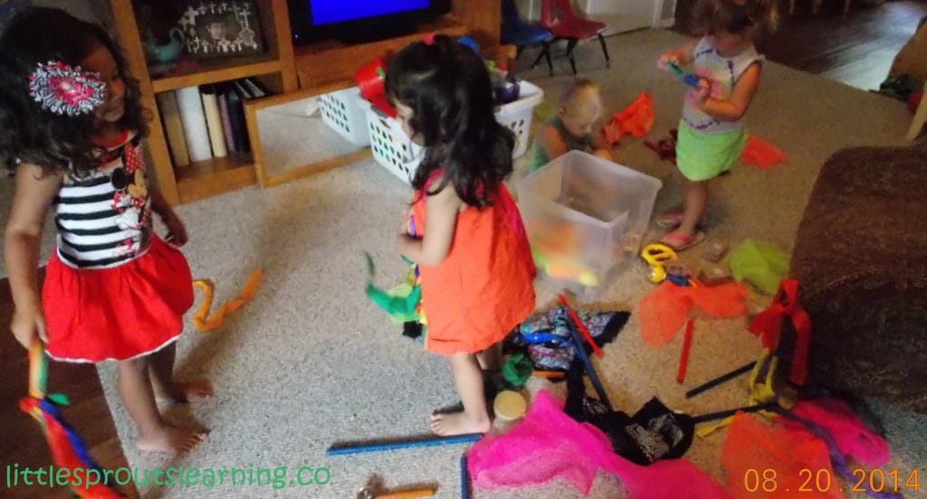 Kids playing with musical instruments and dancing props at daycare