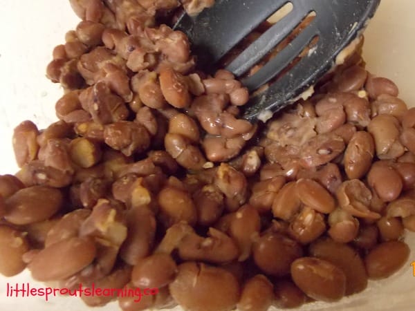 beans cooked with taco seasoning in the crock pot for crock pot taco soup for kids.