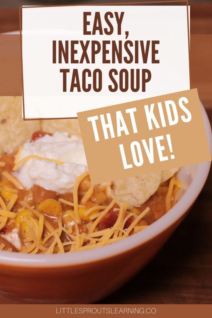 bowl of taco soup topped with cheese, sour cream, and chips