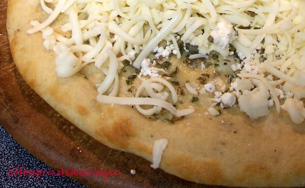 pizza with garlic herb butter and goat cheese and mozzarella cheese