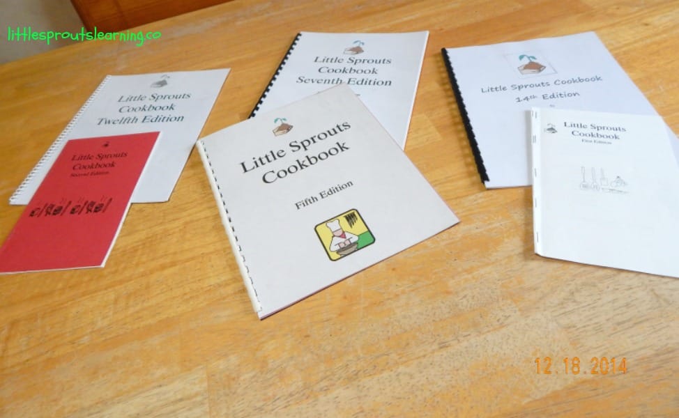 children's cookbooks arranged on a table, some stapled, some bound.
