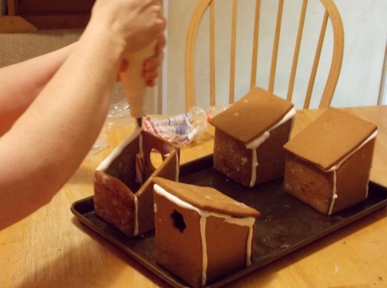 Making your own gingerbread creation and throwing a gingerbread decorating party is so much fun! It's not as hard as you think to put it together.