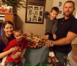 gingerbread creation, family posing with their gingerbread house