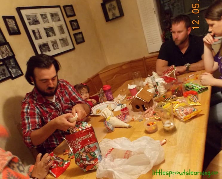 gingerbread fun with families decorating gingerbread houses with candy.