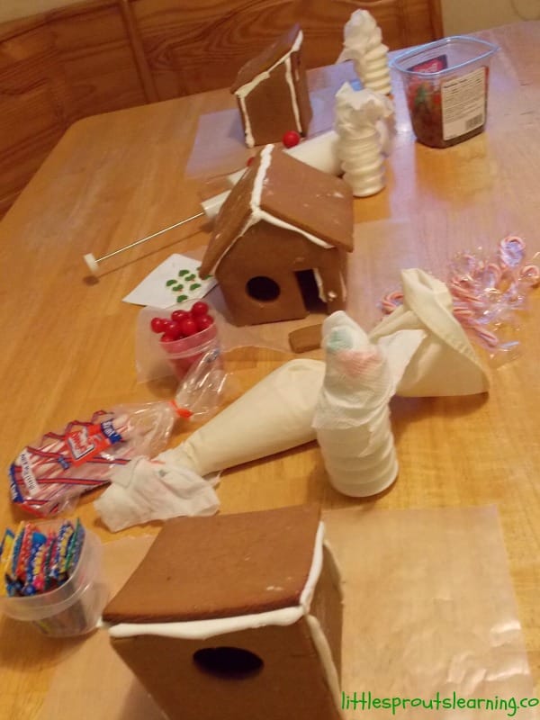 gingerbread houses, just built with suplies for decorating at the gingerbread party.