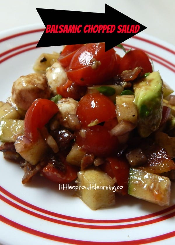 A plate of balsamic chopped salad with tomatoes, avocado, mozzarella, and apples showcases its vibrant ingredients. A text arrow elegantly reads "Balsamic Chopped Salad.