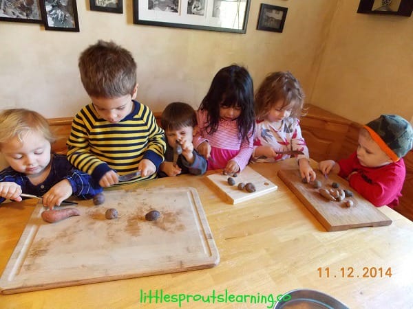 Kids cutting up potatoes to make vegetable beef soup recipe for kids