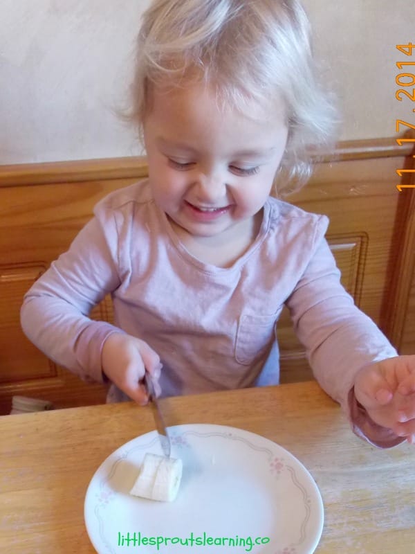 child cutting up bananas for kids cooking class banana bread recipe