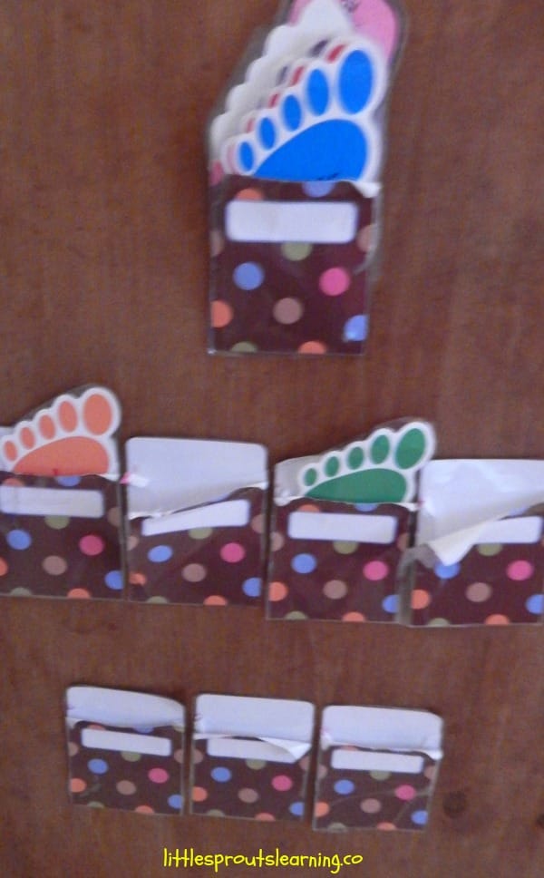 home daycare check in center for kids. Feet with each child's name and envelopes to place them in.