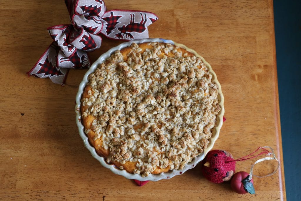 sweet potato casserole on the table with a bow next to it