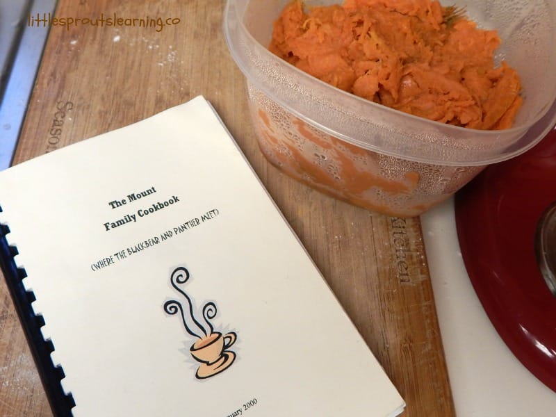 family recipe cookbook and a bowl of mashed sweet potatoes