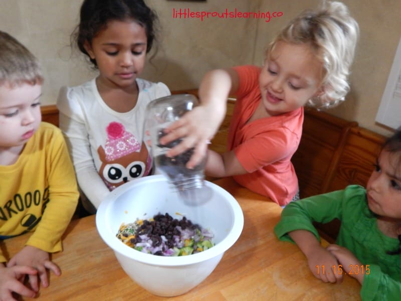 kids cooking a recipes adding ingredients to broccoli salad