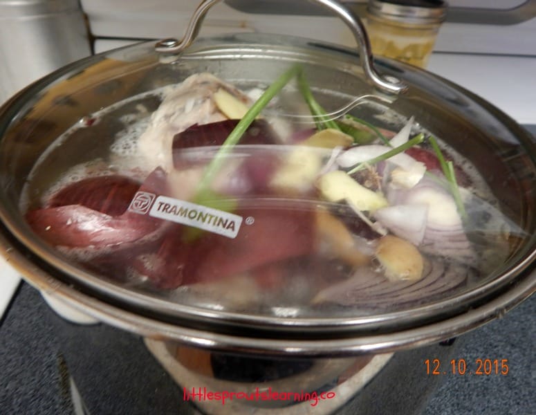 boiling a pot of stock, vegetables and bones in a big pot of water for grass fed bone broth