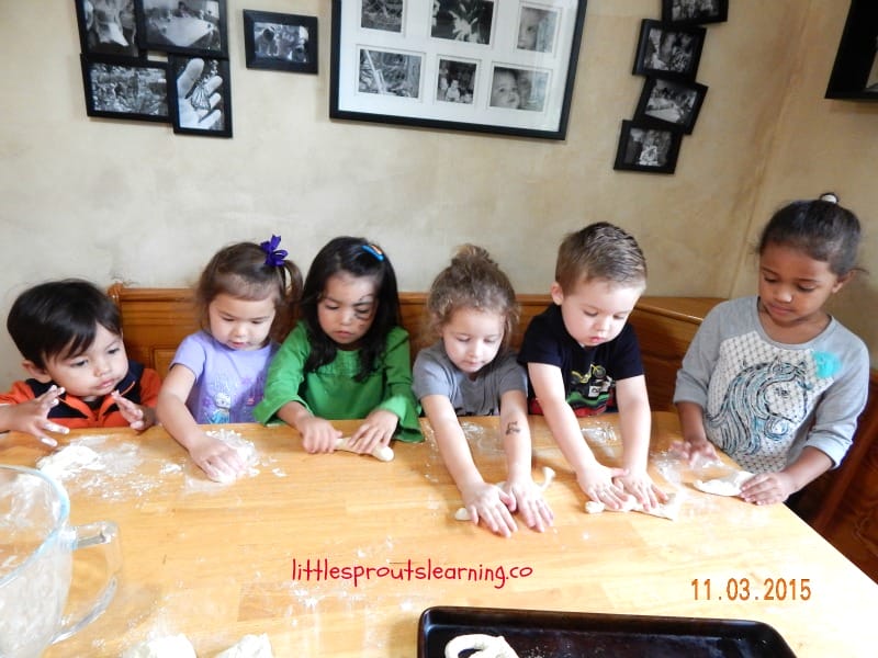 kids rolling homemade pretzel snacks