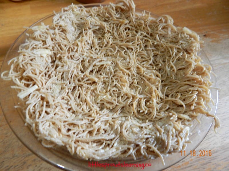 spaghetti pie shell, pressed spaghetti in a pan