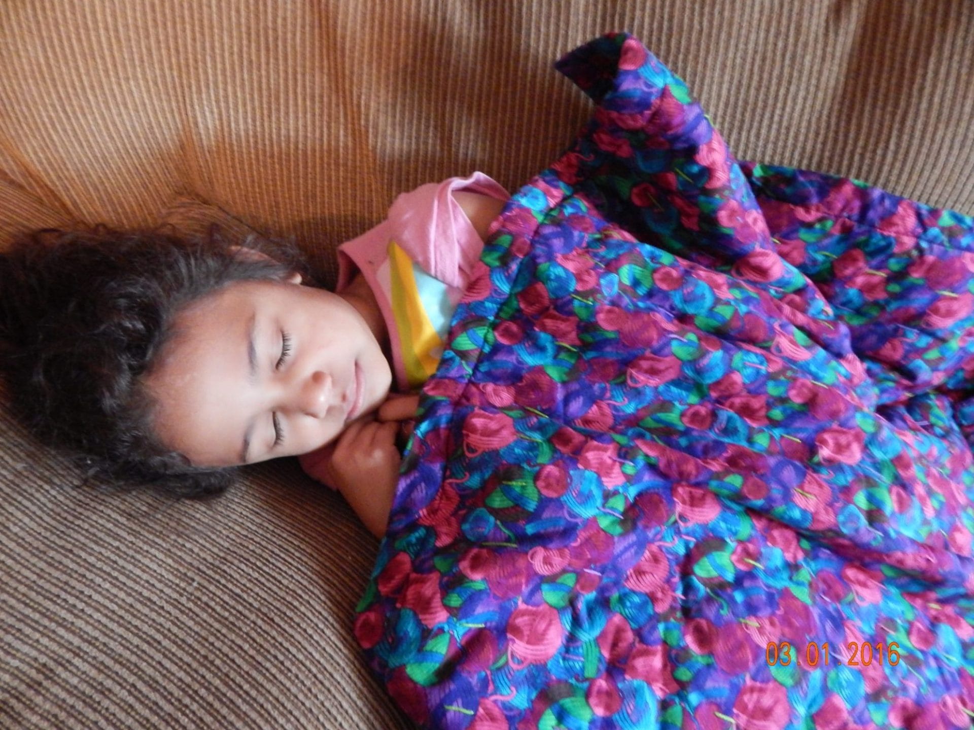 sick daycare kid laying on couch