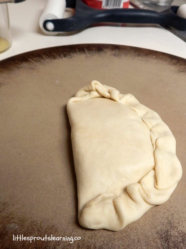 hot pocket, homemade, rolled out, filled and crimped ready to go in the oven.