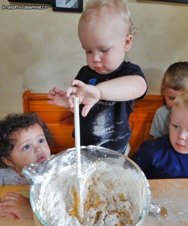 child stirring cookie dough for homemade pumpkin cookies
