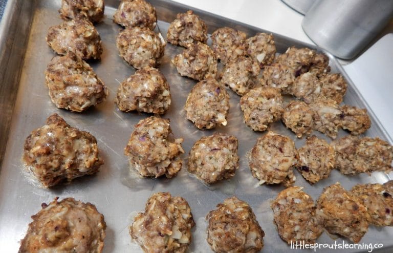 bulk meatballs full of veggies on a sheet pan fresh from the oven