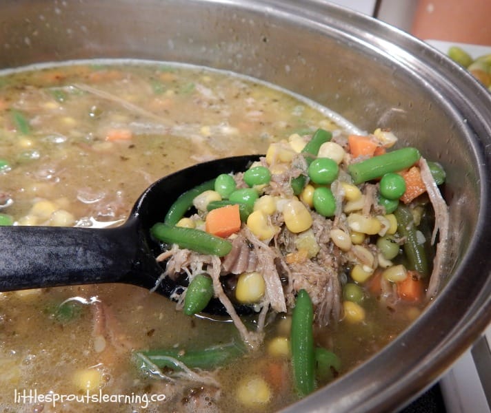 Leftover pork roast and vegetable soup recipe in a pan on the stove