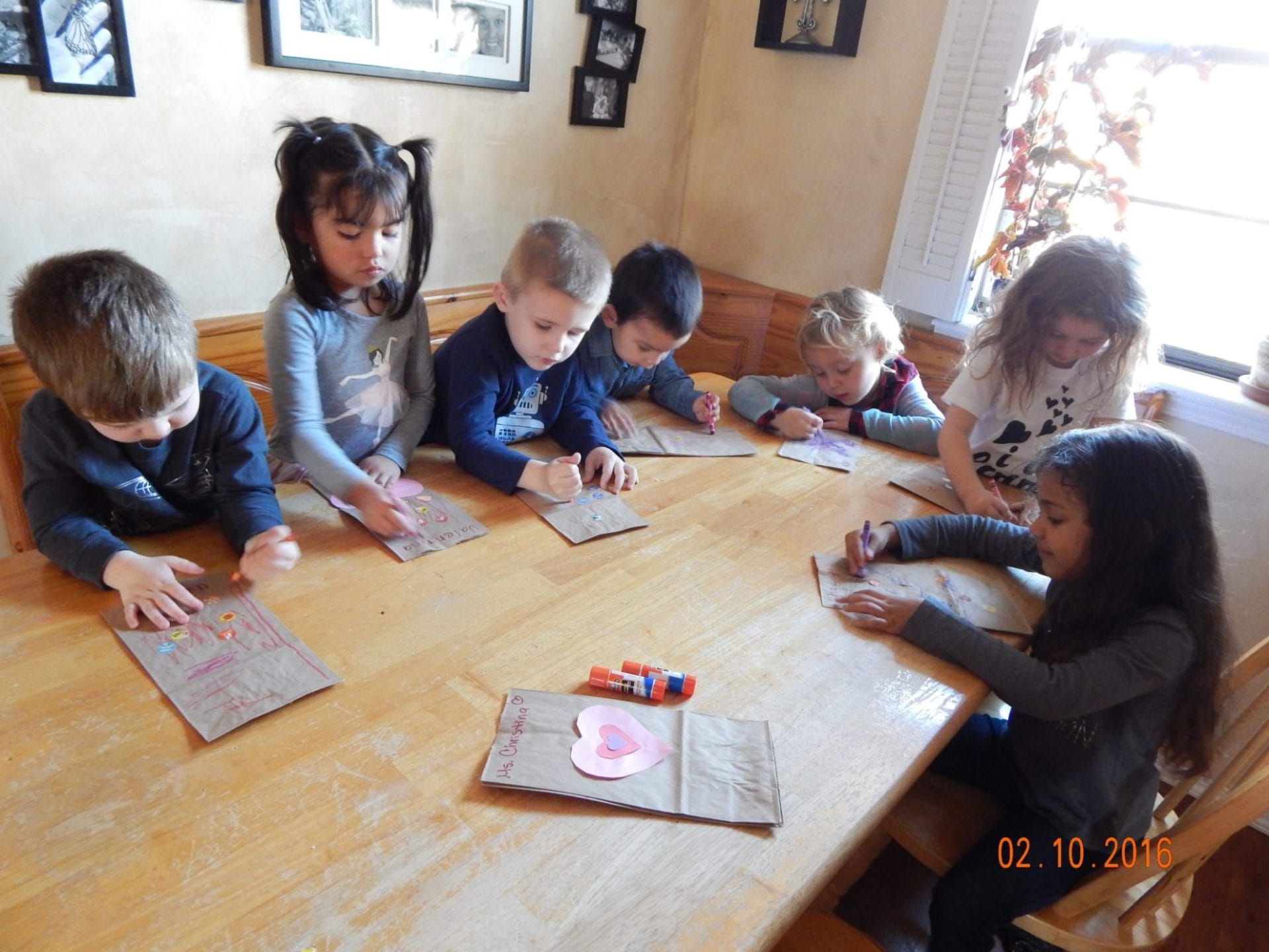 kids valentine party art, making bags for valentine cards to go in.