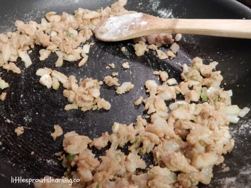 flour and fat in a skillet with onions and hot peppers, making a roux for leftover chicken enchiladas