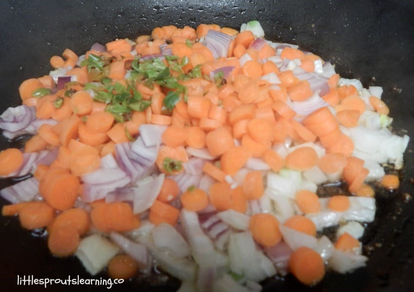 skillet with chopped carrots, onions, and scallions