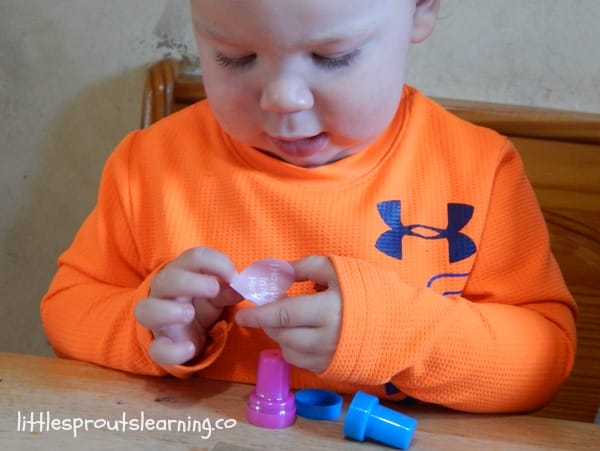 child making valentines day art with stickers and stamps