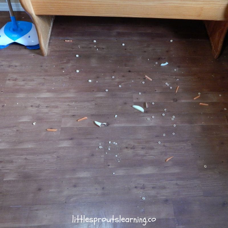 tons of dropped food under kitchen table at daycare, sweep the floor