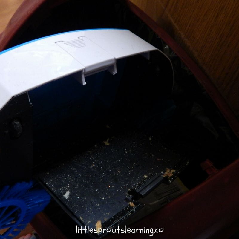 dumping food scraps out of sweeper