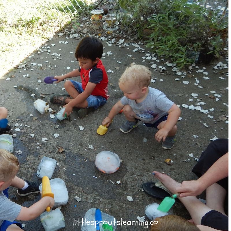 Kids thawing dinosaur glaciers on the back porch in summer time