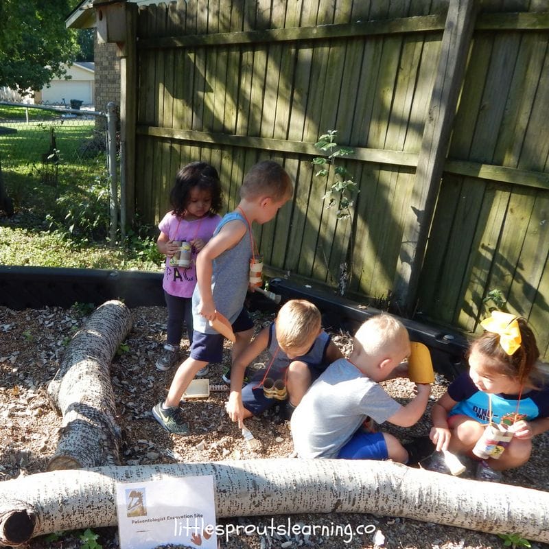 kid paleontologists excavating dinosaur skeletons at dinosaur party