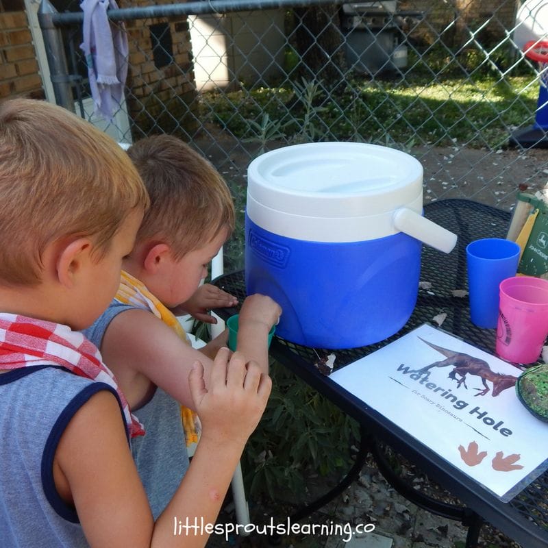 kids getting dinosaur punch from the watering hole at kids dinosaur party
