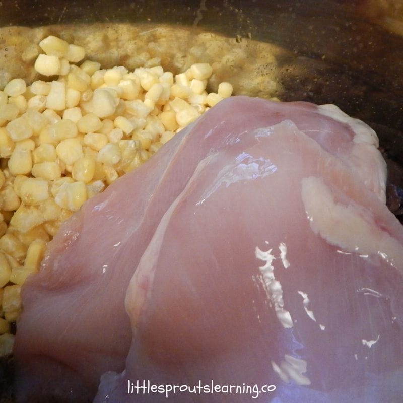 raw chicken breast and frozen corn in instant pot