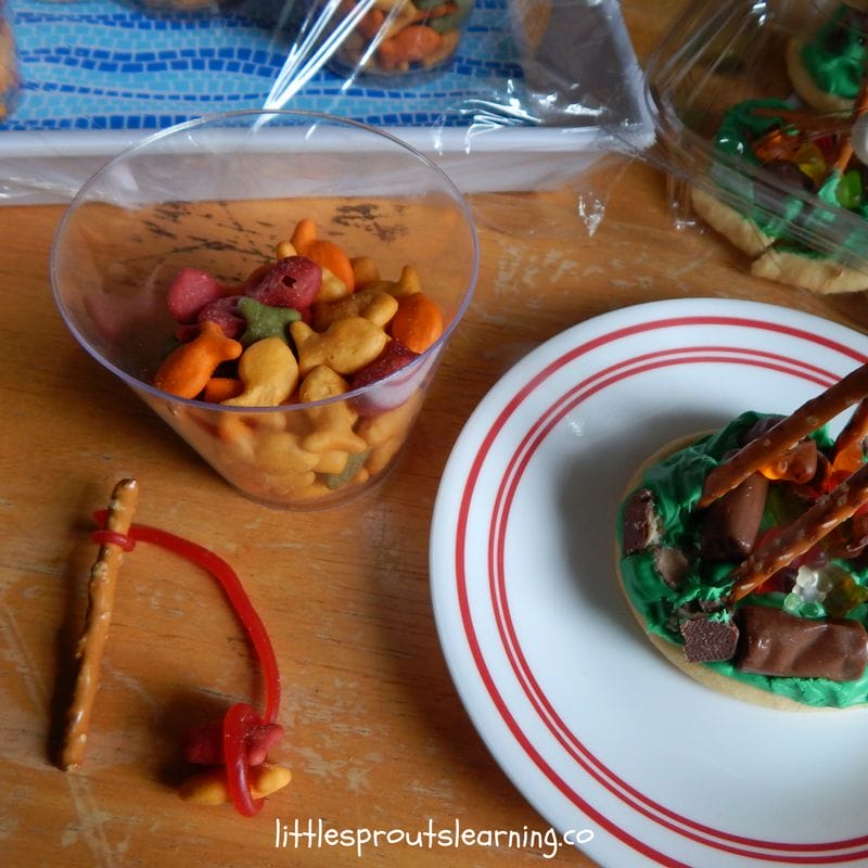 goldish crackers with pretzel fishing poles and campfires on a cookie.