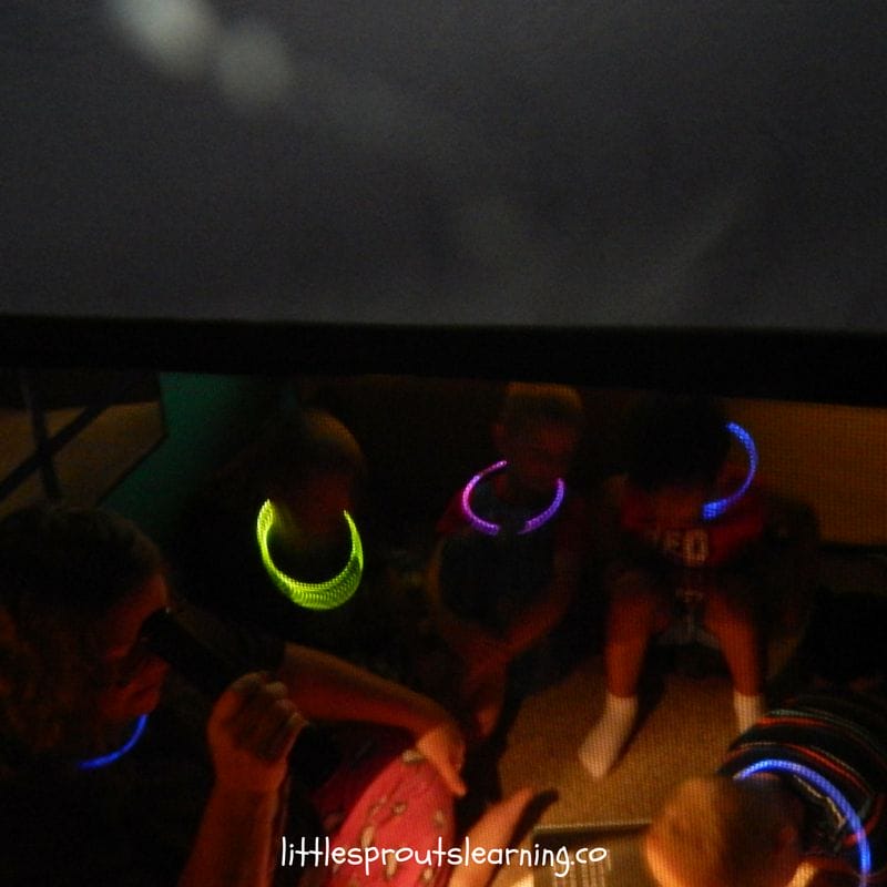 sitting in the tent in the dark having a pretend fire to roast pretend marshmallows.