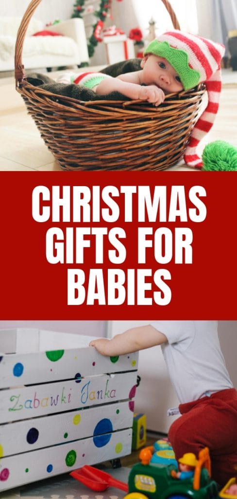 Baby in a basket wearing a christmas hat and baby pulling up to a toy box with toys all around