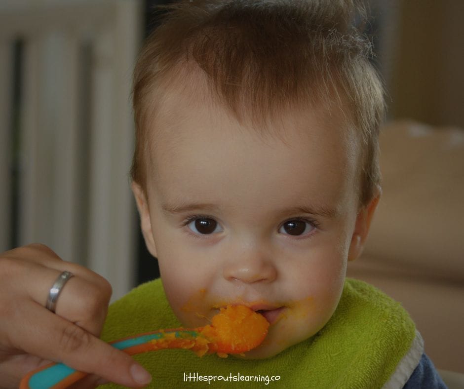 baby eating baby food from a spoon