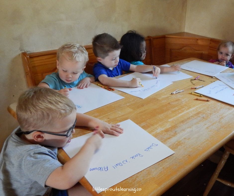 kids decorating album covers making all about me crafts. using crayons to make their personalized all about me album